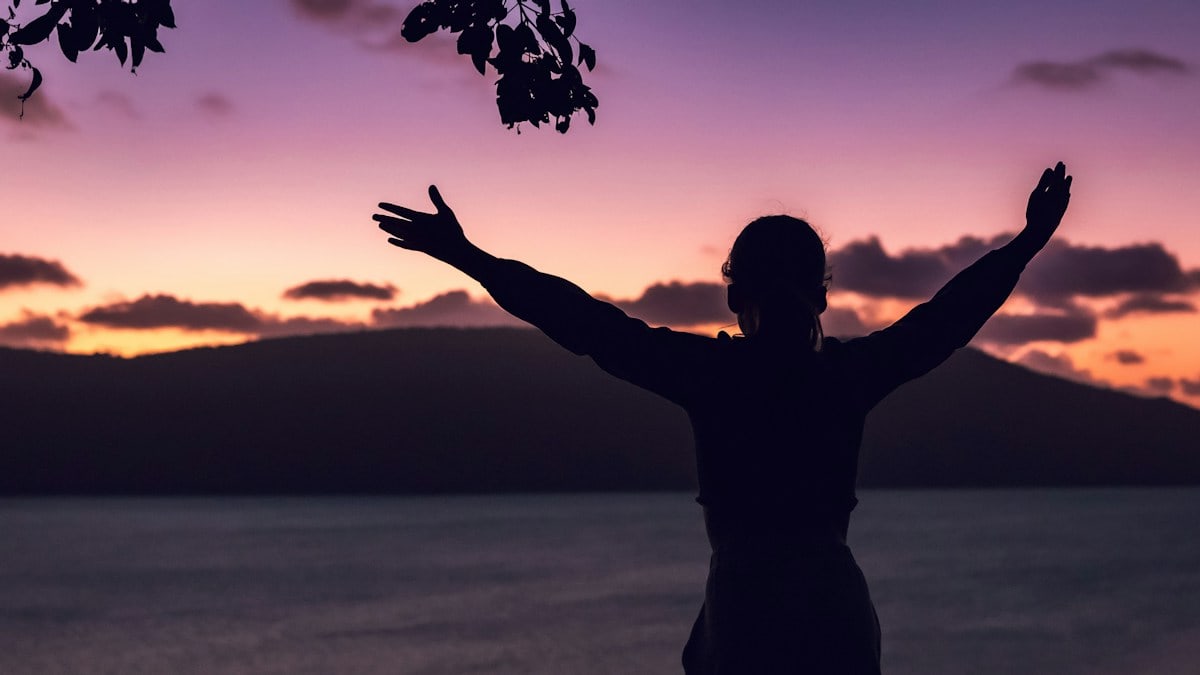 A teenage girl watching the sunset in Australia.